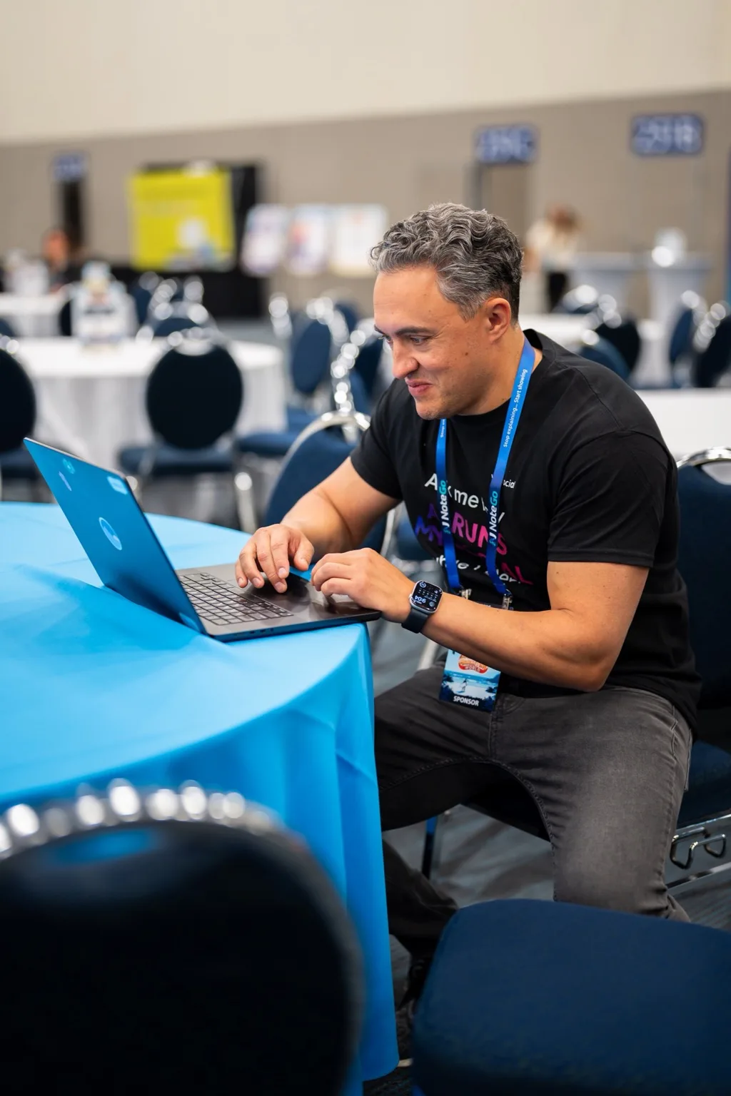 A Vista Social team member working on a laptop at a conference table